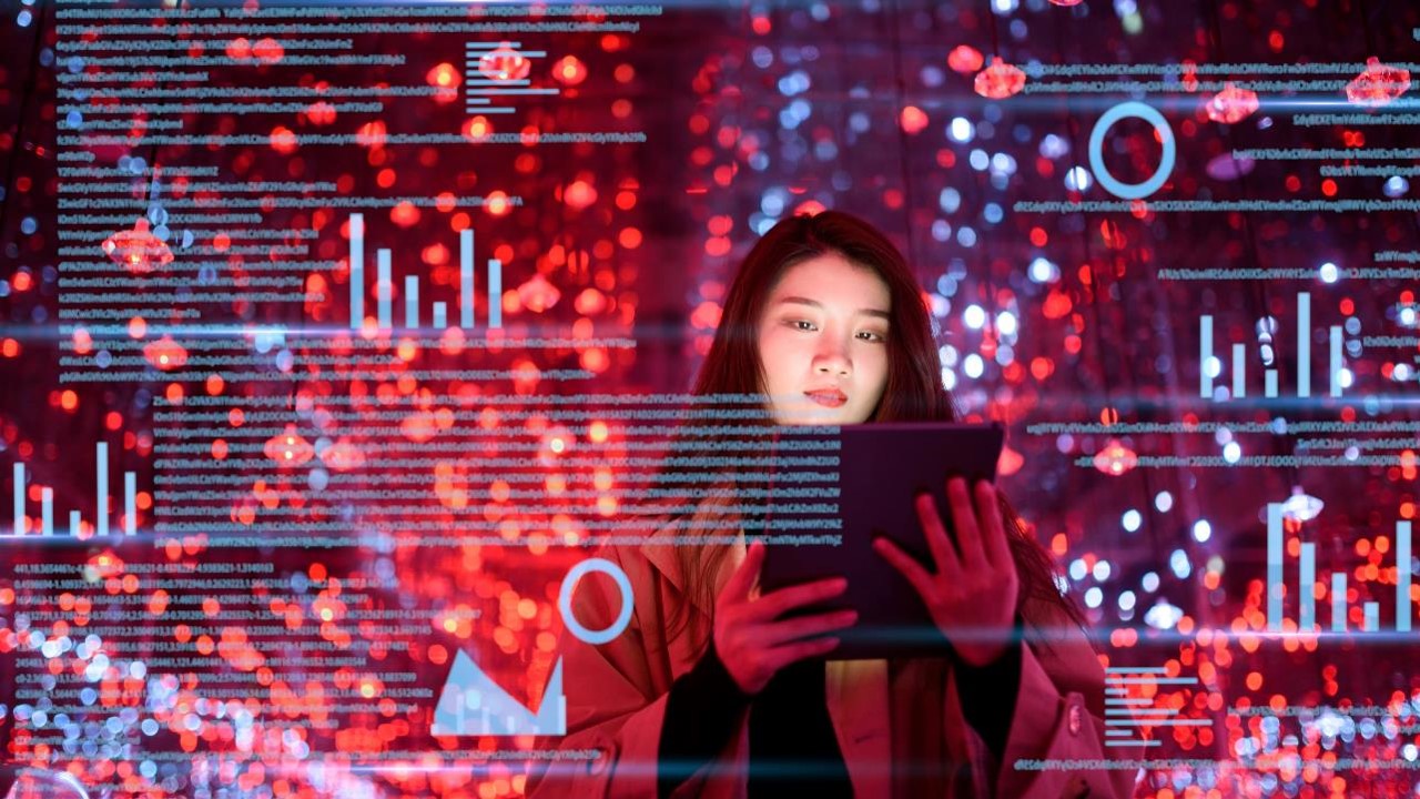 Woman with ipad, surrounded by colourul coding and technological background