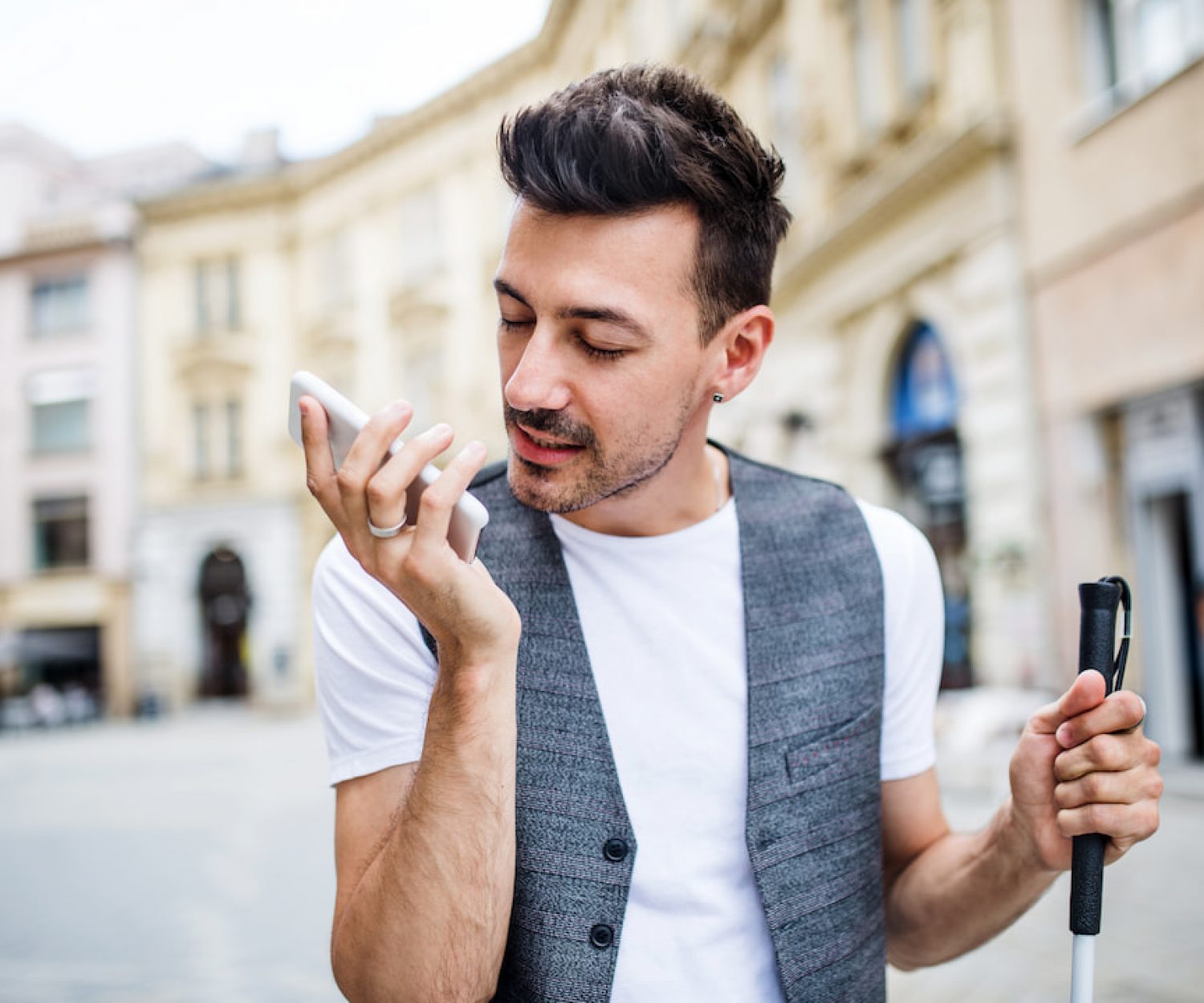 AR accessibility for sight loss - young man with smart phone in square